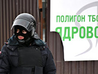 Сотрудник полиции у въезда на территорию полигона твердых бытовых отходов "Ядрово" в Московской области