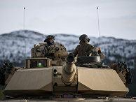 Американские военные на танке Abrams M1 во время военных учений Trident Juncture 2018 в Норвегии Американские военные на танке Abrams M1 во время военных учений Trident Juncture 2018 в Норвегии