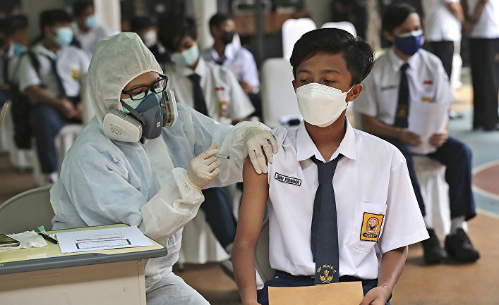 Вакцинация препаратом Sinovac во время кампании по вакцинации детей в возрасте 12-17 в школе в Тангеранге, Индонезия